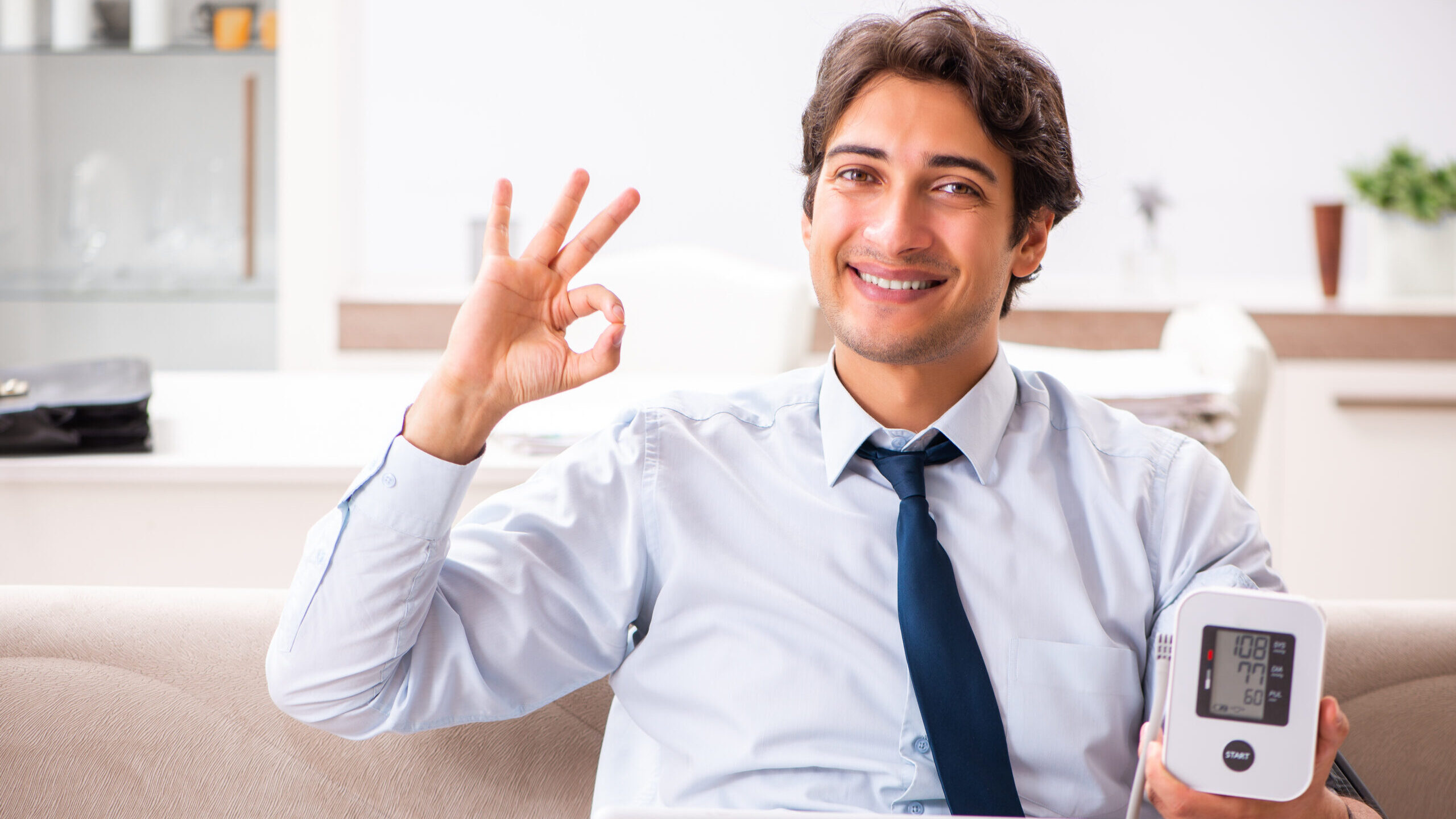 Man under stress measuring his blood pressure